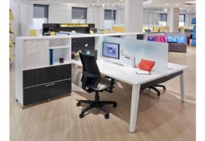 An office cubicle featuring a chair and a storage cabinet